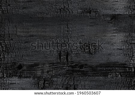 BBQ background. Burned scratched hardwood surface.  Burnt wooden Board texture.  Smoking wood plank background. Burned wooden grunge texture