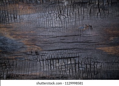BBQ background. Burnt wooden Board texture. Burned scratched hardwood surface. Smoking wood plank background. Dark Burned wooden texture empty horizontal surface, copy  space. Halloween backdrop