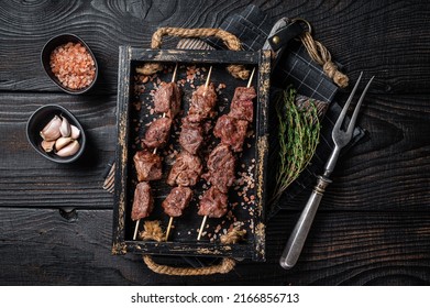 BBQ Beef veal shish kebab Skewers. Black background. Top view.