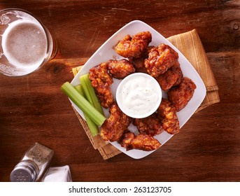 bbq buffalo chicken wings with beer ranch and celery shot top down