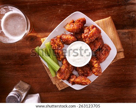 bbq buffalo chicken wings with beer ranch and celery shot top down