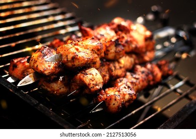 B.B.Q Chicken Boti On Grill With Fire Sparks Background