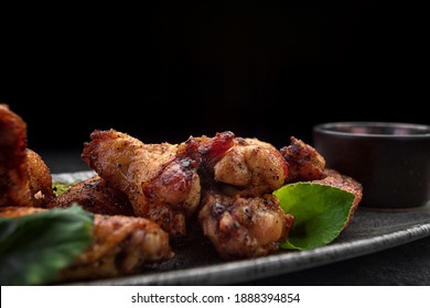 BBQ Chicken Legs With Sauce, On A Gray Plate, On A Dark Background