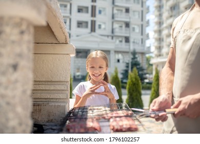 Bbq. Cute Kid Watching Her Dad Grilling Meat