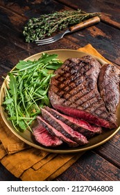 BBQ Dinner With Top Sirloin Beef Steak And Salad On A Plate. Wooden Background. Top View