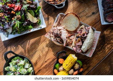 Bbq Food And Sides On Wood Table
Overhead Photo, Spread