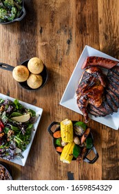 Bbq Food And Sides On Wood Table
Overhead Photo, Spread