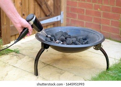 Bbq Grill Charcoal Starting Fire With Hair Dryer In Backyard In England Uk