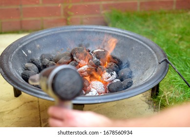 Bbq Grill Charcoal Starting Fire With Hair Dryer In Backyard In England Uk