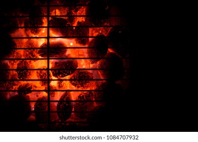 BBQ Grill Pit With Glowing And Flaming Hot Charcoal Briquettes, Food Background Or Texture, Close-Up, Top View