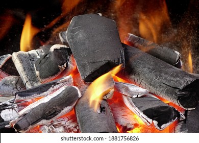 BBQ Grill Pit. Glowing And Flaming Hot Charcoal. Charcoal In Barbecue Grill Pit With Flames Background Texture, Close-up. Flaming Charcoal In Grill Pit Isolated On Black Background.