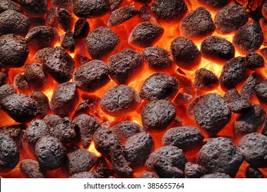 BBQ Grill Pit With Glowing And Flaming Hot Charcoal Briquettes, Food Background Or Texture, Close-Up, Top View