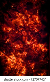 BBQ Grill Pit With Glowing And Flaming Hot Charcoal Briquettes, Food Background Or Texture, Close-Up, Top View