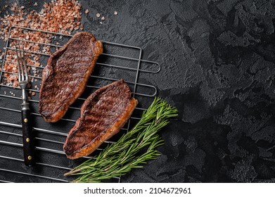 BBQ Grilled Cap Rump Or Top Sirloin Beef Steak, Fried Meat On Grill. Black Background. Top View. Copy Space