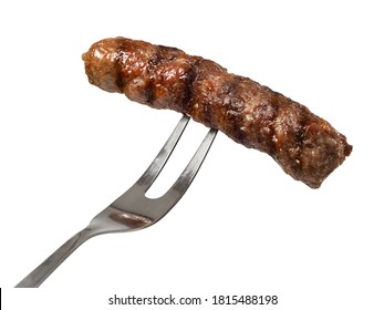 BBQ grilled cevapi on a fork, close up