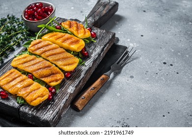 BBQ Grilled Halloumi Cheese With Arugula On Wooden Board. Gray Background. Top View. Copy Space.