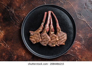 BBQ Grilled Lamb Chops Steaks In A Plate. Dark Background. Top View