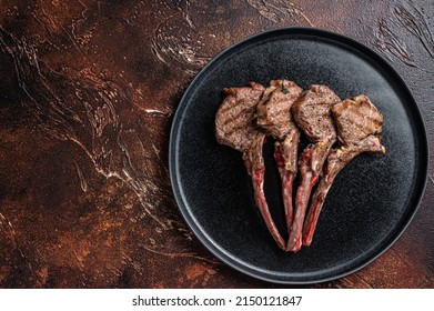 BBQ Grilled Lamb Chops Steaks In A Plate. Dark Background. Top View. Copy Space.