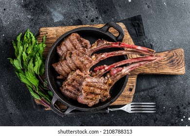 BBq Grilled Lamb Mutton Chops Steaks In A Pan. Black Background. Top View