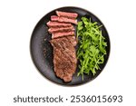 BBQ Grilled Striploin steak on a plate with salad, strip steak, prime roast beef meat isolated on white background.