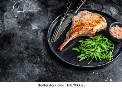 BBQ Grilled Tomahawk Pork Chop Meat Steak On A Marble Board. Black Background. Top View. Copy Space.