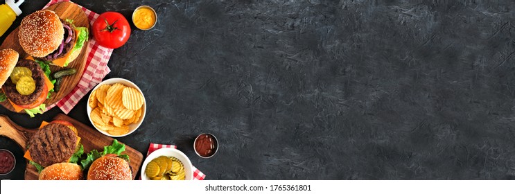 BBQ Hamburger Corner Border. Top Down View Table Scene Over A Dark Slate Banner Background. Copy Space.