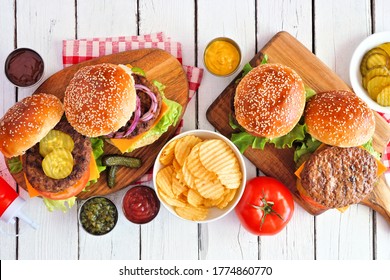 BBQ Hamburger Table Scene. Above View Over A White Wood Background.