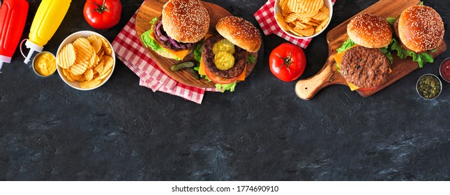 BBQ Hamburger Top Border. Overhead View Table Scene On A Dark Slate Background. Copy Space.