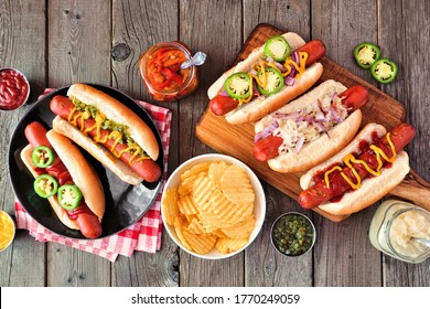 BBQ Hot Dog Table Scene. Above View Over A Dark Wood Background.