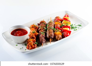 BBQ With Kebab And Grilled Vegetables Isolated On A White Background. Shish Kebab On Skewers