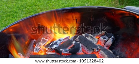 BBQ Kettle Grill With Glowing Hot Charcoal In The Pit. Cookout Food Concept. Outdoor Barbecue Grill With Flaming Coals Ready To Prepare Food On The Backyard Lawn. Abstract Banner.