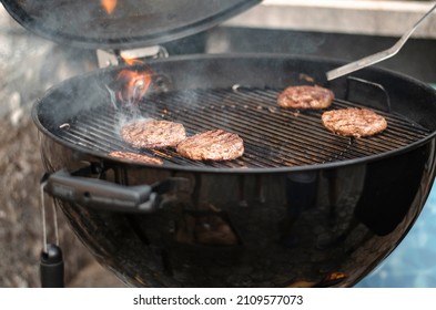 BBQ Making Burgers In Webber Grill On Summer Celebration Day, Barbecue.