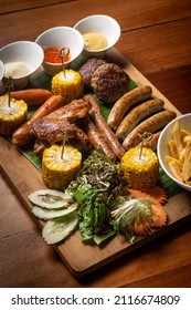 BBQ Mixed Meat Platter With Meatballs, Sausages And Wings On Wood Background