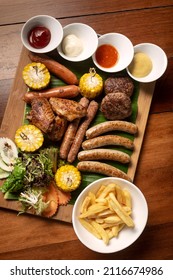 BBQ Mixed Meat Platter With Meatballs, Sausages And Wings On Wood Background