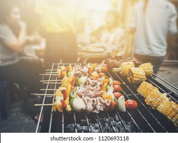 BBQ Party happy summer family dinner at home outdoor vintage style parent and child charcoal stove. - Shutterstock ID 1120693118