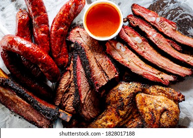 BBQ Platter. Barbecue Brisket, Pork Ribs, Beef Ribs And Chicken Served With Classic Bbq Sides Mac N Cheese, Cornbread, Brussels Sprouts, Coleslaw & Beer. Classic Traditional Texas Meats & Side Dishes.