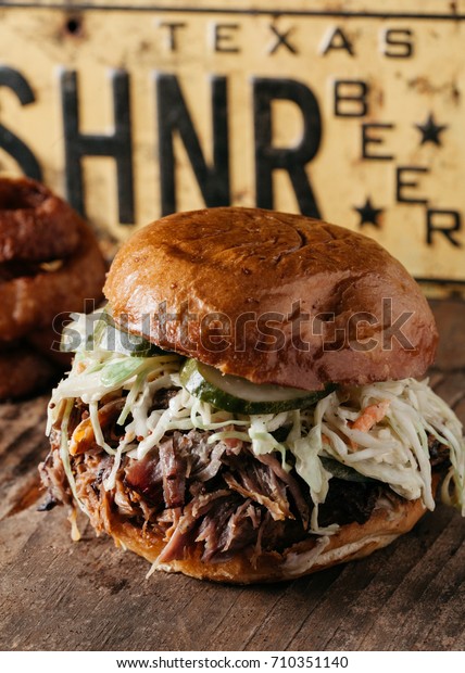 BBQ Pulled Pork Sandwich with coleslaw and dill\
pickles, Texas Style