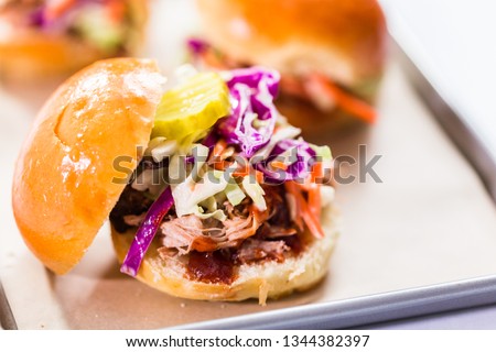 BBQ pulled pork sandwich in shape of small sliders with brioche buns.