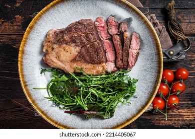 BBQ Roasted Chuck Roll Tender Beef Steak With Salad In Plate. Wooden Background. Top View.