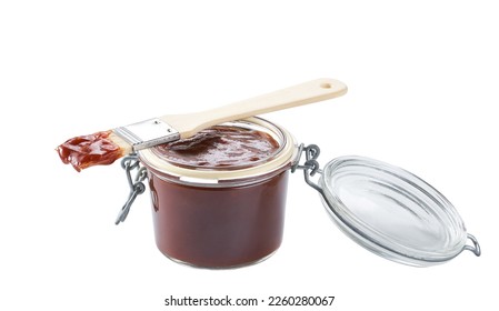 bbq sauce in a jar with barbecue brush isolated on a white background. - Shutterstock ID 2260280067