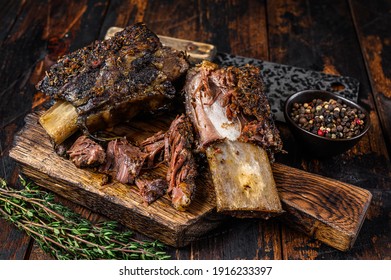 BBQ Short Chuck Beef Ribs With Herbs And Meat Cleaver. Dark Wooden Background. Top View