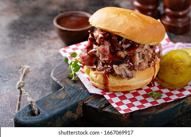 BBQ smoked pulled pork sandwich with pickles and barbeque sauce