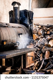 BBQ Smoker Grill And Wood Pile