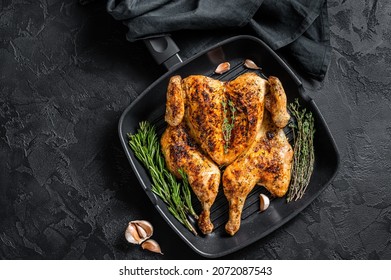 BBQ Spatchcocked Barbecue Whole Chicken On Grill Pan. Black Background. Top View