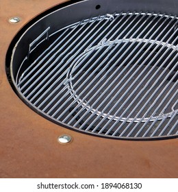 BBQ Stainless Steel Grill And Round Iron Table. Kettle Charcoal Or Propane Barbecue Grill Closeup. Outdoor Large Iron Party Table Top With Barbeque Grill. Top View.