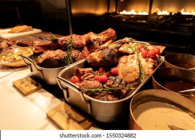 BBQ Station At A Buffet With Prime Rib, Lamb Rack And Sauces