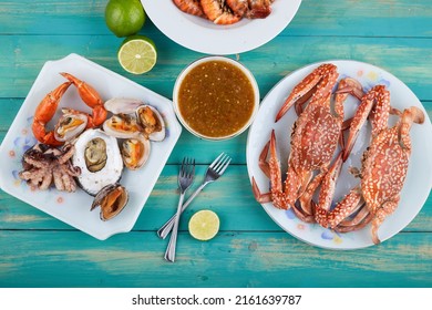 BBQ table seafood party with grilled shrimp squid, crab and thailand dipping sauce. Delicious Grilled barberque seafood Table outdoor  party home garden ready to eat
