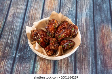 BBQ Wings With Lots Of Sauce Drizzled With Sesame Seeds, Chopped Chives And Cardboard Bowl For Home Delivery