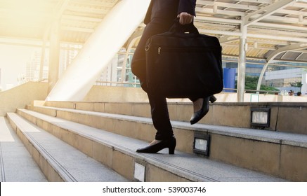 Bbusinesswoman In High-heels Stepping Down Stairs And Carrying Laptop Bag