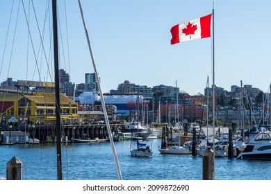 BC, Canada - April 4 2021 : National Flag Of Canada And Vancouver Marina. Granville Island Public Market. Concept Of Canadian Urban City Life.